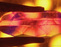 Curved growth lines in synthetic Verneuil ruby.