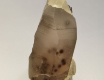 Quartz crystal with dark areas of smoky quartz, produced by natural irradiation