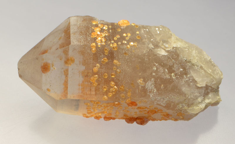 Spessartine in quartz rough